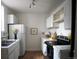 Well-lit kitchen featuring white cabinets, appliances, and a white tiled backsplash and countertops at 215 E 11Th Ave # A5, Denver, CO 80203