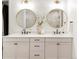Bright bathroom featuring double sinks, updated fixtures, and modern, round mirrors at 1925 W 165Th Way, Broomfield, CO 80023