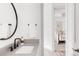 Stylish bathroom features a gray counter, white sink, matte black faucet, mirror and decorative soap dispenser at 1925 W 165Th Way, Broomfield, CO 80023