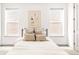 Cozy bedroom with a bed, neutral linens, a decorative art piece and two windows that brings in lots of natural light at 1925 W 165Th Way, Broomfield, CO 80023