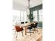 A dining room with modern light fixture, wood floors, and plenty of natural light at 1925 W 165Th Way, Broomfield, CO 80023