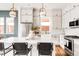 This modern kitchen features bright cabinetry, stainless appliances, and contemporary pendant lighting at 1925 W 165Th Way, Broomfield, CO 80023