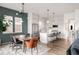 Open concept kitchen and dining area featuring an island, modern appliances, and a view of the backyard at 1925 W 165Th Way, Broomfield, CO 80023