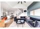 Open-concept living room with modern decor, hardwood floors, and view of the adjacent kitchen at 1925 W 165Th Way, Broomfield, CO 80023