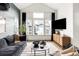 Bright living room boasts a large picture window, hardwood floors, and stylish contemporary decor at 1925 W 165Th Way, Broomfield, CO 80023