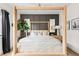 Tranquil main bedroom featuring a four-poster bed, modern decor, and a large window at 1925 W 165Th Way, Broomfield, CO 80023