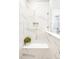 Elegant shower featuring marble style tile, shower seating, and recessed shower storage at 1925 W 165Th Way, Broomfield, CO 80023