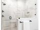 Bright and spacious shower featuring marble style tile, sleek glass enclosure, and modern fixtures at 1925 W 165Th Way, Broomfield, CO 80023