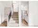 Carpeted staircase with a view of a bathroom with white fixtures, black shower, and a tiled shower at 1925 W 165Th Way, Broomfield, CO 80023