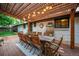 Spacious backyard patio with large wooden table and chairs set up for outdoor dining at 3125 Xenon St, Wheat Ridge, CO 80215