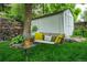 Relaxing backyard features a charming swing bench, lush lawn, and mature shade tree, creating a tranquil retreat at 3125 Xenon St, Wheat Ridge, CO 80215