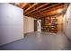 Unfinished basement with painted floor and open ceiling at 3125 Xenon St, Wheat Ridge, CO 80215