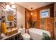 Unique bathroom featuring wood shutter walls, copper fixtures, and a stone vessel sink at 3125 Xenon St, Wheat Ridge, CO 80215