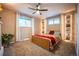 Bright bedroom with large windows, built-in shelving, carpeted floor and ceiling fan at 3125 Xenon St, Wheat Ridge, CO 80215