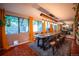Large dining room boasting big windows and a modern light fixture over a long table set for many guests at 3125 Xenon St, Wheat Ridge, CO 80215