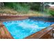 In-ground hot tub surrounded by wood decking with hydrotherapy jets at 3125 Xenon St, Wheat Ridge, CO 80215