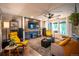 Inviting living room features a brick fireplace, hardwood floors, neutral walls, and comfortable seating at 3125 Xenon St, Wheat Ridge, CO 80215