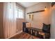 Bright mudroom featuring a window, bench with storage, and hooks for hanging items at 3125 Xenon St, Wheat Ridge, CO 80215