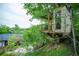 Backyard treehouse with seating, hammock, and treetop views adds to the lush landscape at 3125 Xenon St, Wheat Ridge, CO 80215