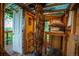 Cozy treehouse interior with wood finishes, storage space, and a tree at 3125 Xenon St, Wheat Ridge, CO 80215