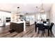 Open concept dining area with a large table and modern lighting fixture at 521 Garden Sage Ct, Castle Rock, CO 80104