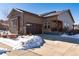 House exterior with attached garage and snowy yard at 521 Garden Sage Ct, Castle Rock, CO 80104