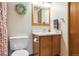 Functional bathroom with a wooden vanity, toilet, and a decorative wreath, offering a practical space at 98 N Quicksilver Ave, Castle Rock, CO 80104