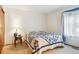 Bright bedroom with a quilt-covered bed, side table and lamp at 98 N Quicksilver Ave, Castle Rock, CO 80104