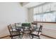 Dining area with a glass table and four chairs, offering a modern and stylish space for meals at 98 N Quicksilver Ave, Castle Rock, CO 80104