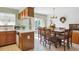 Bright dining area featuring a wooden table with seating for eight, and a slider to the backyard patio at 98 N Quicksilver Ave, Castle Rock, CO 80104