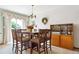 Bright dining room features a chandelier, modern cabinet, and a large window with sheer curtains at 98 N Quicksilver Ave, Castle Rock, CO 80104