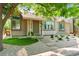 A charming exterior view of a well-maintained home with front yard landscaping and mature trees at 98 N Quicksilver Ave, Castle Rock, CO 80104