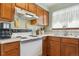 Close-up view of a well-maintained kitchen with white appliances and oak cabinets at 98 N Quicksilver Ave, Castle Rock, CO 80104