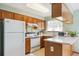 Functional kitchen with white appliances, wooden cabinets, and bright countertops at 98 N Quicksilver Ave, Castle Rock, CO 80104