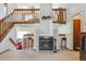 Open-concept living room features a fireplace, high ceilings, and a view of the upper-level balcony at 98 N Quicksilver Ave, Castle Rock, CO 80104