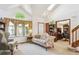 Bright living room with a vaulted ceiling, floral sofa, and open access to the study and staircase at 98 N Quicksilver Ave, Castle Rock, CO 80104