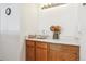 Practical sink and vanity area featuring wooden cabinetry and a neutral countertop, providing essential functionality at 98 N Quicksilver Ave, Castle Rock, CO 80104