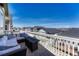 Relaxing deck area with outdoor furniture, fire table, and neighborhood views at 2153 Abigail Ln, Castle Rock, CO 80104