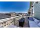 Relaxing deck area with outdoor furniture, fire table, and neighborhood views at 2153 Abigail Ln, Castle Rock, CO 80104