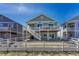 Back exterior view showing a deck and stairs with a fenced yard and patio at 2153 Abigail Ln, Castle Rock, CO 80104