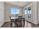 Bright dining area with a wooden table, pendant lighting, and access to the outdoors, creating an inviting space at 2153 Abigail Ln, Castle Rock, CO 80104