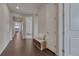 Hallway with a bench and storage baskets and a view to a dining room and bedroom at 2153 Abigail Ln, Castle Rock, CO 80104