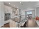 Modern kitchen with stainless steel appliances, large island, and stylish pendant lighting at 2153 Abigail Ln, Castle Rock, CO 80104