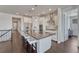Modern kitchen with stainless steel appliances, large island, and stylish pendant lighting at 2153 Abigail Ln, Castle Rock, CO 80104