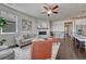 Bright living room featuring a stone fireplace, comfortable seating, and an open layout perfect for entertaining at 2153 Abigail Ln, Castle Rock, CO 80104