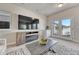 Inviting living room with a fireplace, large TV, and access to outdoor patio through double doors at 2153 Abigail Ln, Castle Rock, CO 80104