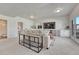 Comfortable living room with large TV, a console table, and access to the outside through glass doors at 2153 Abigail Ln, Castle Rock, CO 80104