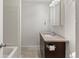 This bathroom features a dark vanity and medicine cabinet and a shower and bathtub combo at 865 S Quebec St # 101B, Denver, CO 80247
