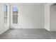 This bedroom has carpeted floors, a window, and a neutral-toned color palette at 865 S Quebec St # 101B, Denver, CO 80247