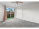 Bright bedroom with sliding glass door that leads to outdoor patio, white walls, and gray carpet at 865 S Quebec St # 101B, Denver, CO 80247